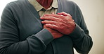 Hands, chest pain and senior man in home with discomfort, angina or heart attack symptoms. Respiratory illness, medical emergency and elderly person with cardiac problem, asthma or artery disease.