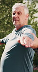 Senior, man and warrior pose with trainer outdoor, exercise and wellness with stretching for posture. Male person, coach and help with advice for yoga, fitness and balance with support in nature