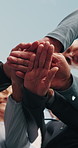 Blue sky, people and hands together with huddle for fitness, support and health celebration. Nature, teamwork and personal trainer with stack for solidarity, exercise goal or motivation in low angle