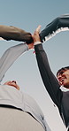 Blue sky, people and hands together with high five for fitness, support and celebration. Nature, teamwork and personal trainer with huddle for solidarity, exercise goal or motivation in low angle