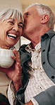 Tea, kiss and senior couple with laugh in home for funny chat, healthy marriage or connection. Affection, happy people or conversation joke with drink in house for bonding, retirement support or love
