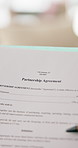 Person, hands and document with partnership agreement for legal contract, policy form or deal. Paper, partner or binding application for shared responsibility, investment or development together