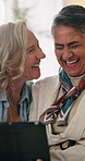 Tablet, mature and lgbt couple in house with laugh, bonding together or discussion for funny movie. Happy, lesbian women and talk in lounge with tech, relationship and humor for romantic comedy show.