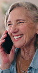 Mature, woman and laugh in house with phone call, funny conversation and gossip update on weekend. Happy, female person relax and tech in living room with contact, humor and joke for communication.