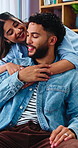 Hug, couple and love on sofa with smile, bonding and gossip in apartment living room. Embrace, happy man and woman with communication in house with relationship, relax or chat in home with support