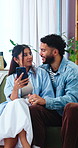 Smile, couple and holding hands at house with phone, social media and website for online shopping. Happy, people and talking in lounge with mobile, streaming movies and app subscription for ecommerce