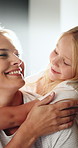 Happy mom, hug and bonding with child in home, love and laughing with daughter on weekend and relax. Family house, connection and woman with smile for girl, support and affection for kid or childcare