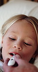 Temperature, sick and child in bedroom at house with allergies, flu or viral infection on weekend. Thermometer, illness and hand of parent with girl kid for monitoring fever symptoms in bed at home.
