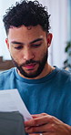 Laptop, logistics and paper with man in home office for delivery, distribution or shipping. Computer, online order and documents with freelancer in apartment for ecommerce or supply chain business