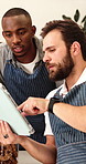 Waiter, team and talking with tablet in cafe for barista training, order entry and POS system. Small business, men or manager with restaurant app for online stock, explain menu or hospitality service