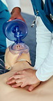 CPR, hands and nurse training with mannequin for healthcare, first aid practice or emergency rescue. Medical workers, chest compression and people with dummy in ventilator mask for learning at clinic