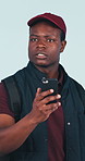 Man, phone and food delivery in studio with bag, lost and search location for online order address. Confused, black person and tech for takeaway courier, digital map and guide on blue background.