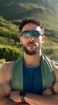 Fitness, arms crossed and face of man at beach for runner gear, glare protection and sunglasses. Athlete, flare prevention lens and training with person outdoor for confidence, workout and exercise
