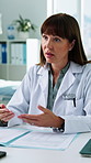 Consulting, talking and doctor in hospital with paperwork for discussion, diagnosis and medical service. Healthcare, clinic and woman in conversation for patient appointment, advice and treatment