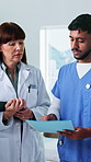 Doctor, nurses and meeting in hospital with folder, planning or update for patient medical condition. Healthcare manager, people and discussion in clinic with file, test results and diagnosis report.
