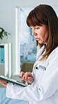 Medical, research or woman in hospital with tablet, review or patient diagnosis in online consulting. Healthcare, typing or mature doctor with technology, telehealth or case report for treatment plan