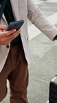 Businessman, hands and phone with suitcase in city for work trip or business travel. Man, employee or traveler with smartphone or luggage for app, career opportunity or job commute in an urban town