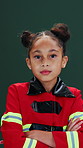 Firefighter, costume and face of kid in studio with crossed arms for future, career day and ambition. Serious, portrait and girl in uniform for rescue service, safety or dream job on green background