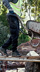 Construction, walking and man with wheelbarrow outdoor for materials, tools and building site. Excavation, architecture and person with equipment for renovation, infrastructure or maintenance project