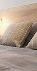 Hospitality, closeup and bed in hotel, empty and mattress with pillows, bedding and interior design.  Luxury, accommodation and cozy blanket in bedroom, comfort and tidy motel or travel destination