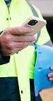 Typing, phone and hands of architect on construction site with chat, inspection or email for feedback. Technology, man and civil engineer with app for texting with building or renovation approval
