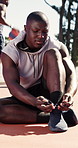 Man, tying and shoes on court for basketball, getting ready and exercise safety for wellness. Athlete, male person or secure laces in nature with sneakers, competition preparation and sports training