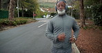 Fitness, running and man with headphones in road for health workout, morning cardio or playlist. Active, mature black person and jog in neighborhood for exercise, physical activity or music streaming
