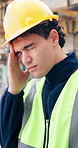 Man, engineer or headache with stress on construction site for overworked, pressure or injury. Frustrated, male person or architect with pain for building accident, strain or inspection mistake