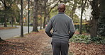 Cardio, fitness and man on road, running and endurance for physical activity or active for wellness. Outdoor, runner and mature person with energy for jog, back and workout routine for health in city