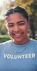 Pride, face and volunteer in park with laugh, outreach worker or about us as charity ambassador. Bokeh, happy woman or NGO activist with humor, humanitarian aid or confidence in social responsibility