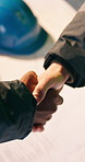 Construction, blueprint and people with handshake for meeting, agreement and architecture project. Engineering, building and workers shaking hands for partnership, planning and remodeling with layout