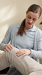 Physiotherapist, consultation and woman with knee exam in clinic for recovery, wellness or health. Physical therapy, checkup and medical worker with patient for assessment, mobility or rehabilitation