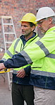 Men, pointing and tablet at site for construction, research and inspection report for architecture. People, talking and team at worksite with digital, maintenance checklist and building development
