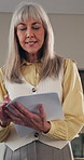 Woman, teacher and talking in classroom with paper, assignment and school quiz for education. Person, teaching and students at campus with documents, exam revision and assessment results for learning