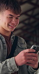 School, laugh and boy with phone typing for social media, online chat and lesson schedule. Student, happy and teenager on cellphone for internet, message and funny text for education in hallway