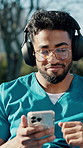 Man, medical student and music with phone in park for streaming, relax or break at campus. Person, smile and headphones with subscription, tech and listen to album outdoor at healthcare college