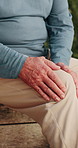 Senior, person and hands with knee pain for joint inflammation, discomfort or arthritis in home. Elderly, leg or injury with sore ache, massage or strain for fibromyalgia or muscle tension in house