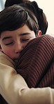 Boy, mom and hug with love in home for family comfort, bonding weekend or holiday together. Child, kid or mother with embrace, safety or protection for youth, connection or gentle parenting in house