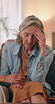 Sad, woman and conversation in home with friends, emotional support and empathy for healing from grief. Upset, mature people and comfort on couch with trust, holding hands and talk to process trauma.