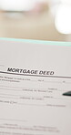 Person, hands and document with mortgage deed for legal contract, policy agreement or deal. Paper, reading or binding application with pen for property investment, financial loan or asset management