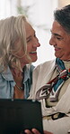 Tablet, mature and lesbian couple in house with love, browsing social media or people bonding together. Happy, lgbt women and talk in lounge with tech, internet connection and romantic relationship.