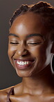 Beauty, funny and wellness with black woman in studio for hydration results or satisfaction. Aesthetic, glow and shine with person laughing on dark background for collagen, skincare or vitamin c