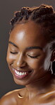 Beauty, laughing and wellness with black woman in studio for hydration results or satisfaction. Eyes closed, glow and shine with funny person on dark background for collagen, skincare or vitamin c