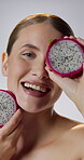 Dragon fruit, face and smile of woman in studio for cosmetics, gut health or skincare. Aesthetic, beauty and vitamin c with happy person on white background for dietary fibre, nutrition or wellness
