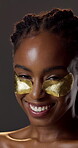 Beauty, eye mask and face of black woman in studio for hydration treatment or satisfaction. Gel patches, glow  and shine with happy person on dark background for collagen, skincare or vitamin c