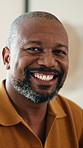 Happy, relax and face of black man in home for break, calm and peaceful weekend in morning. Smile, confident and portrait of mature person with pride for positive attitude in living room at house.