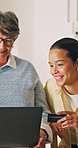 Senior, woman and laptop with credit card help for online shopping assistance or guidance in home. Elderly, female person or shipper with assistant or debit on computer for ecommerce app in house