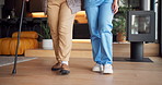 Nurse, legs and walking patient with cane in retirement house for assistance living or mobility. Healthcare worker, caregiver or helping person with a disability for elderly care in nursing home