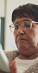 Senior, woman and online in house with tablet, glasses and browsing website for retirement planning. Pensioner, female person and relax in home with tech, research and digital app for life insurance.