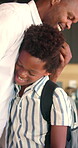 Happy dad, hug and child with backpack in kitchen, back to school or getting ready with boy and love. Black people, family and morning routine with father, education and support for kid in house